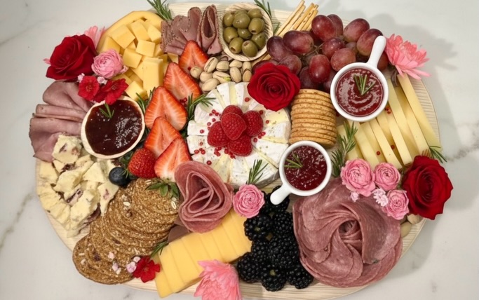 Valentine's charcuterie board with roses and berries